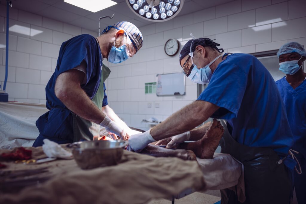 Medical team performing surgery in a hospital operating room.