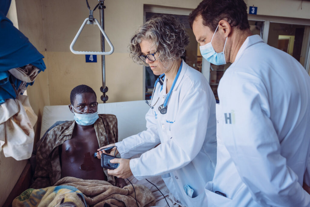 Healthcare professionals caring for a patient in a medical mission setting.