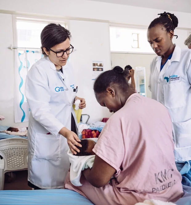 Doctor supporting a mother practicing kangaroo care with her newborn